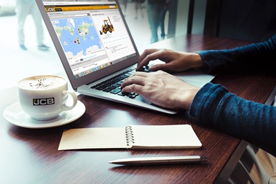 Male working with computer laptop on wood bar